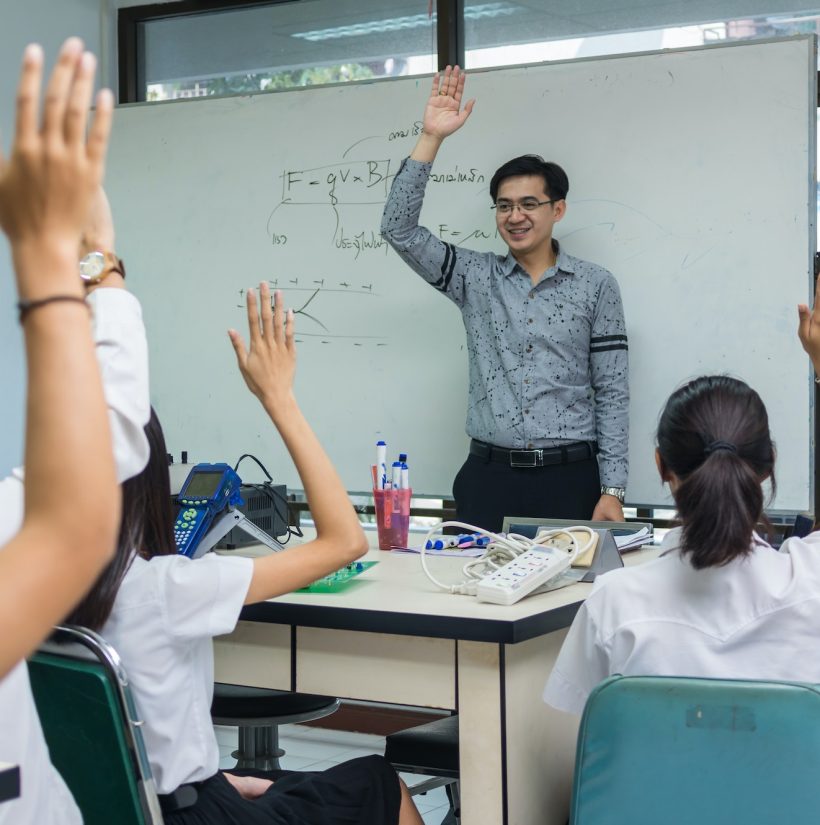 Asian teacher Giving Lesson over the the physics formular on white board in science laboratory